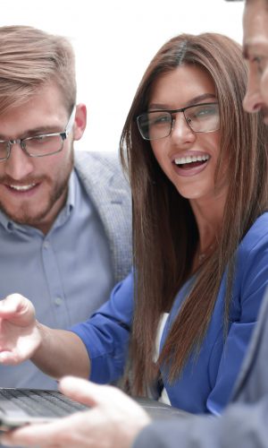 close up.employees with a laptop discussing new information . photo with copy space